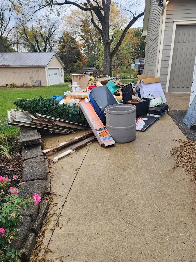 Dumpster being loaded with debris for Estate Cleanout Dumpster Rental in Lumberton